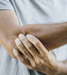 Elbow experiencing physical impact of psoriatic arthritis with dactylitis or enthesitis